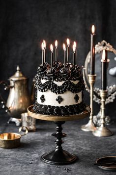 a black and white cake with candles on it