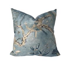 a blue pillow with birds on it