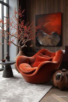 an orange chair sitting on top of a rug next to a vase filled with flowers