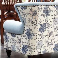 a blue and white chair sitting on top of a hard wood floor