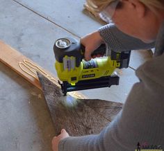 a woman using a power tool to cut wood planks with a jig saw