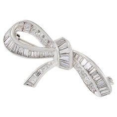 Expertly crafted with an elegant Art Deco design, this Platinum Estate Diamond Bow Brooch boasts a staggering 2.00 carats of round cut diamonds graded F in color and VS in clarity. Experience the timeless luxury and brilliance of fine diamonds with this stunning piece of jewelry. Art Deco Brooch, Diamond Bows, Elegant Art, Diamond Brooch, Art Deco Period, Art Deco Era, Antique Art Deco, European Cut Diamonds, Art Deco Diamond