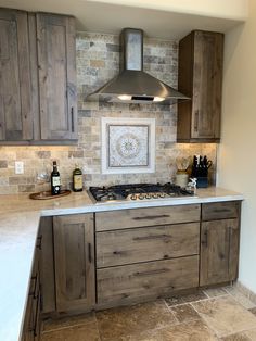 a stove top oven sitting inside of a kitchen next to wooden cupboards and counter tops