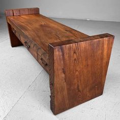 a wooden bench sitting on top of a white floor