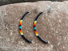 Here's a pair of Black with Native Colors Beaded Half Hoops that are lightweight and comfortable to wear all day long. Made with high quality glass Delica Beads, beaded one bead at a time.  Love and passion goes into making my jewelry.  This process requires focus, patience, and dedication.  Each bead is 16th of an inch and can take hours to complete a project.  These half hoops are 2 inches long.  Beautiful earrings for everyday wear. This would make a great gift for someone special or a treat Beaded Hoop Earrings Native American, Indian Beadwork, Beautiful Beaded Earring, Easy Cash, Beading Inspiration, Stick Earrings, Beaded Earrings Tutorials, Beaded Earrings Diy, Native American Beaded Earrings