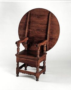 a wooden chair with an arm rest and back rests against a white background, in the shape of a circle