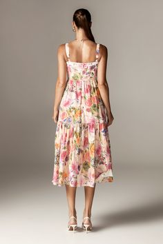 Embrace timeless elegance with the Andrea Bloom Rose Cotton Midi Sundress, a standout piece from our Golden Hour collection. Crafted from luxurious stretch cotton-rich fabric, this sundress features a flowy tiered skirt and a structured corseted bodice, exuding ultra-feminine charm. The pretty neckline with underwired cups adds to its romantic allure, while practical pockets enhance its appeal. Adjustable shoulder straps ensure a perfect fit, and the billowing, tiered skirt creates a dramatic silhouette. The dress is fully lined with airy viscose for ultimate comfort and features a convenient back zipper for easy wear. Where To Wear:Italian city sightseeing, with a cardigan over the shoulders for crisper mornings, picnics by the river, garden parties, and afternoon tea dates. Stretch Facto Pink Tiered Skirt Midi Dress For Garden Party, Feminine Tiered Midi Dress For Summer, Feminine Tiered Skirt Midi Dress For Vacation, Feminine Tiered Summer Midi Dress, Fitted Tiered Sundress For Daywear, Feminine Tiered Dress For Vacation, Feminine Midi Length Tiered Summer Dress, Summer Tiered Skirt Midi Dress For Garden Party, Summer Tiered Midi Dress For Garden Party