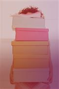 a stack of books with a woman's head resting on top