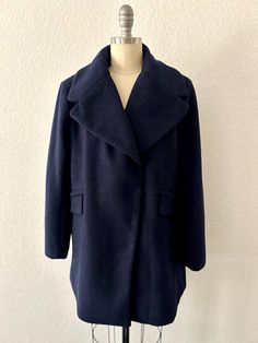 1990s Vintage FRNCH peacoat Minimalist Navy Peacoat Dramatic Shawl/Notched Collar 5 snap front closure  2  Side pockets w/faux welt flap Belt Tab accent in back Complete lining and intact Material:   Shell  75.5% poly, 25.5% wool Lining  100% poly Size:  S Bust:  34" Sleeves:  23" Length:  31" Shoulder-to-shoulder:  16" Condition:  Very Good vintage condition, minimal pilling throughout Navy Peacoat, Minimalist Chic, Notched Collar, Womens Jackets, Shawl, Wool Blend, Jackets & Coats, Jackets For Women, Wool