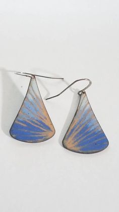 "I make these earrings by torch firing enamel onto copper. I fired transparent ckear enamel as the first layer, which looks like shiny gold and various shades of blue on top. I've drawn a pattern into the enamel before torch firing. - this technique is called sgraffito. This copper drop shape about 1 1/4\" long. They are shown on a silver plated ear wire which is nickel and lead free. Total length of earring including earwire is 1 3/4\" long. These are fun and colorful earrings. These are defini Blue Artisan Copper Earrings, Artisan Blue Copper Earrings, Unique Blue Copper Earrings, Blue Copper Teardrop Earrings, Blue Teardrop Copper Earrings, Artsy Blue Teardrop Earrings, Blue Teardrop Earrings With Patina, Blue Teardrop Patina Jewelry, Blue Patina Earrings For Gift