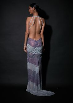 Editor's Note Ready to slay in a backless gown - choose this double tone crystal embellished backless gown with a trail for the added drama. Fabric: Net Color: Lilac, silver Component: Gown Neckline: Plunge Sleeve type: Sleeveless Occasion: Cocktail and party Care: Dry Clean Only About the Designer Itrh makes a high-end luxury Indian ethnic wear made using exquisite and endangered age-old crafts such as kalamkari, madhubani, chikankari, zardozi, and gota weaving. The focus of the house is to che Gown With Trail, Backless Gown, Tunic Designs, Gown For Women, Embellished Gown, Cute Bras, Skirt Co Ord, Gowns Online, Indian Ethnic Wear