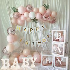 a baby shower with balloons and decorations on the table for it's first birthday