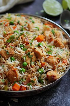 a close up of a plate of food with rice and vegetables in it on a table