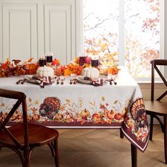 a thanksgiving table setting with turkeys and candles