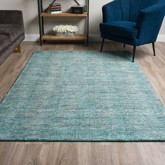 a living room with two chairs and a blue rug