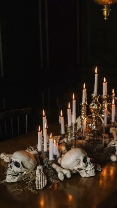 a table topped with lots of candles and skulls