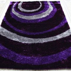 a purple and grey rug on the floor