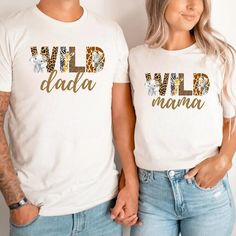 two people wearing matching shirts with wild and mamma written on the front in gold letters