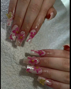 two hands with pink and gold flowers on them