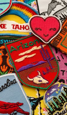 several patches with different colors and designs are shown in this close up photo, including the words arizona on them