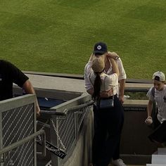 two baseball players hug each other as they walk up the stairs