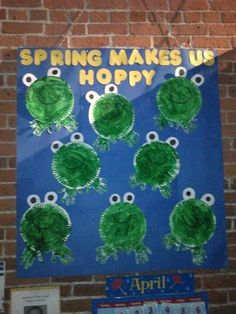 a sign that says spring makes us hoppy on the side of a brick wall