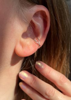 These criss cross ear cuffs are made with .925 sterling silver wire; available individually or as a pair.  Make sure to visit rosemarymystic dot com for more one-of-a-kind creations✨ To put on ear, gently slide into place. Can be adjusted slightly by carefully pressing or pulling on the ear cuff for a better fit, but be careful not to push or pull too hard or too quickly! To keep your silver ear cuffs looking their best do not wear while swimming or bathing. As a general rule - your jewelry shou Cuff Earrings No Piercing, Earring Cuff, Minimalist Ear Cuff, Wrap Earrings, Silver Ear Cuff, Natural Lighting, Ear Cuffs, Cuff Earrings, Product Photos