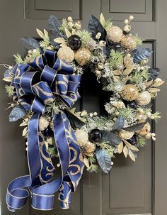 a blue and gold christmas wreath on a door