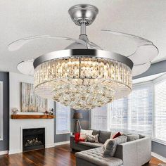 a living room filled with furniture and a large chandelier hanging from the ceiling