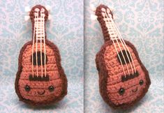 a crocheted ukulele sitting on top of a blue and white wall