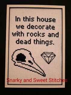 a cross stitch picture with the words in this house we decorate with rocks and dead things