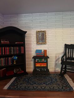 a room with two chairs, a book shelf and a rug