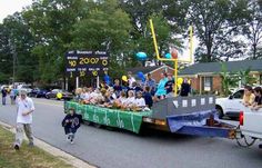 people are riding in the back of a truck with balloons and streamers on it