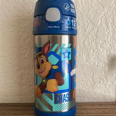 a blue insulated cup with a cartoon character on it