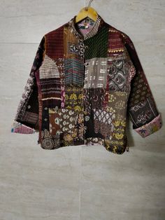 a patchwork jacket hanging on a wall