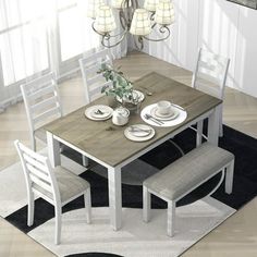 a dining room table with four chairs around it