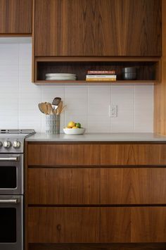 a kitchen with wooden cabinets and stainless steel appliances