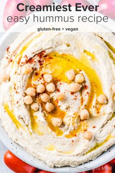 hummus in a white bowl with chickpeas on top and text overlay