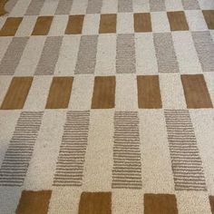 a brown and white checkered rug on the floor