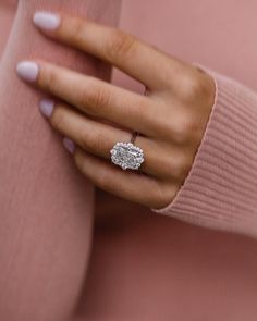 a woman's hand with a diamond ring on it