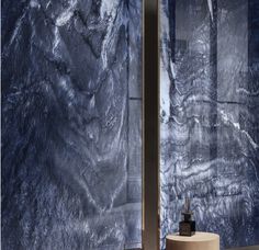 two large blue marble walls in a room