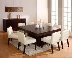 a dining room table with white chairs around it