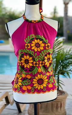 Beautiful embroidered halter top made in Mexico. This is a perfect gift for any occasion or to add to your collection. * Imported from Cuernavaca, Morelos Mexico * Beautiful Bold Bright Colors * Tie around the neck * Elastic around the back for comfort * Embroidered Flowers * One size Small/Medium * 100% Handmade * Cotton Blend * Light Burgundy Mexican Motifs, Light Burgundy, Womens Halter Tops, Mexican Dresses, Halter Tops, Mexican Style, Embroidered Flowers, Halter Top, Diy Clothes