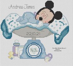 a cross stitch pattern with a baby mickey mouse sleeping on top of a weighing scale