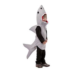 a young boy wearing a shark costume