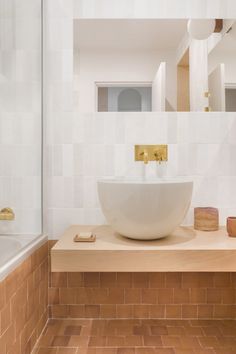 a bathroom sink sitting on top of a wooden counter