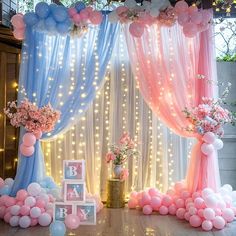 a decorated stage with balloons, flowers and decorations for a baby's first birthday