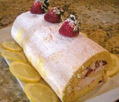 a cake with lemon slices and strawberries on top