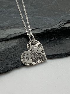 This beautiful silver heart necklace pendant has been entirely handmade using .999 fine silver. It has been cut from fine silver precious metal clay, textured, fired and oxidized. The pendant hangs from a sterling silver diamond cut cable chain. This unique and handmade necklace features an embossed rose floral leaf branch pattern. Pendant size: approximately 1/2 x 1/2 inches Chain length: adjustable at 16 and 18 inches can also be customized to whatever length needed The necklace is sent in a g Boho Jewelry Bracelet, Precious Metal Clay Jewelry, Oxidised Silver Jewelry, Remembrance Jewelry, Bracelets Design, Metal Clay Jewelry, Pendant Necklace Silver, Precious Metal Clay, Floral Heart