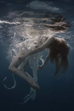 a woman is submerged in the water